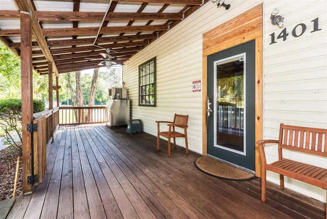 a view of outdoor space with wooden floor and seating