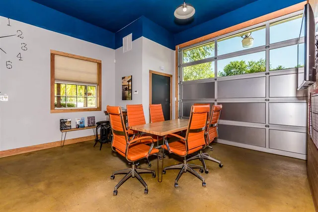 a dining room with furniture and a window