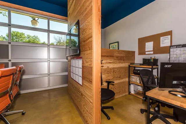 a kitchen with stainless steel appliances kitchen island granite countertop a refrigerator and cabinets