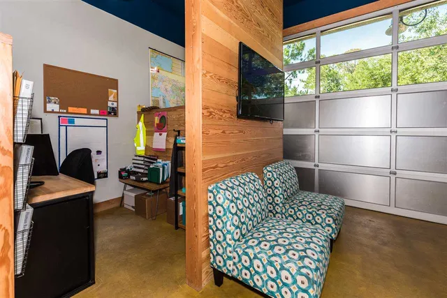 a room with furniture a rug and a window