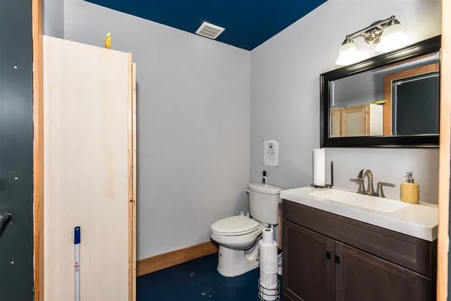 a kitchen with kitchen island a sink a stove and a refrigerator