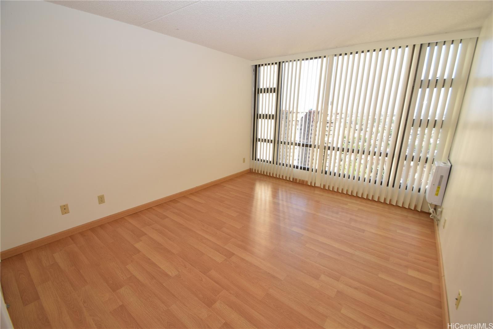 98-402 Koauka Loop, Unit 1916 Aiea, HI 96701 - Photo 12 of 24 an empty room with wooden floor and windows