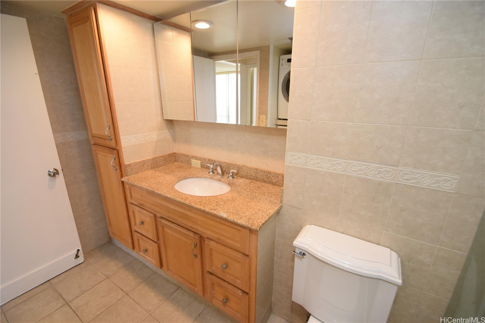 98-402 Koauka Loop, Unit 1916 Aiea, HI 96701 - Photo 17 of 24 a bathroom with a sink a toilet and a mirror