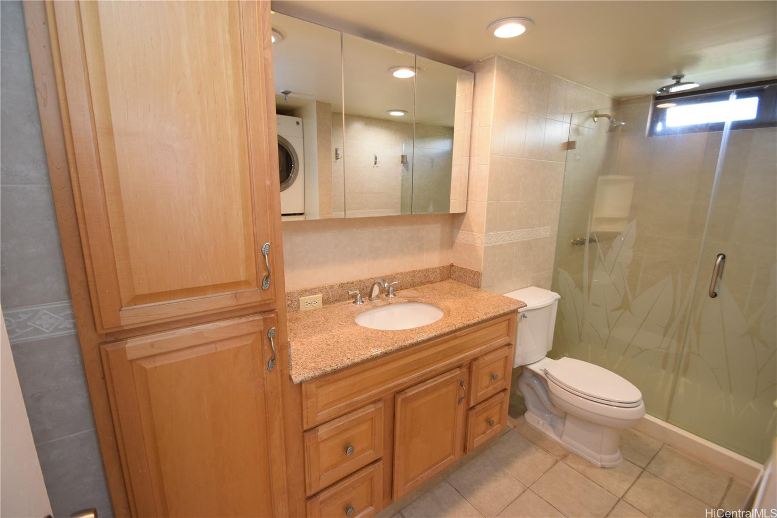 98-402 Koauka Loop, Unit 1916 Aiea, HI 96701 - Photo 20 of 24 a bathroom with a sink a toilet and shower