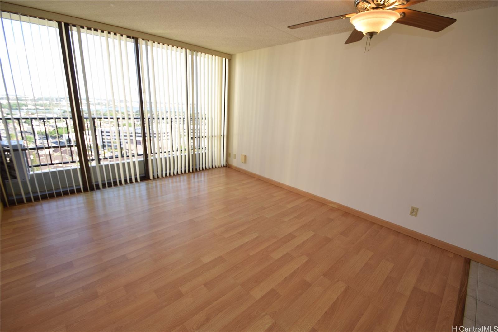 98-402 Koauka Loop, Unit 1916 Aiea, HI 96701 - Photo 22 of 24 wooden floor in an empty room with a window