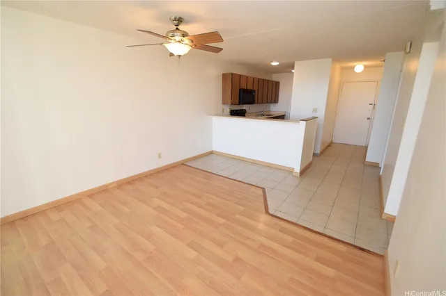 a view of a kitchen with a sink and a chandelier fan