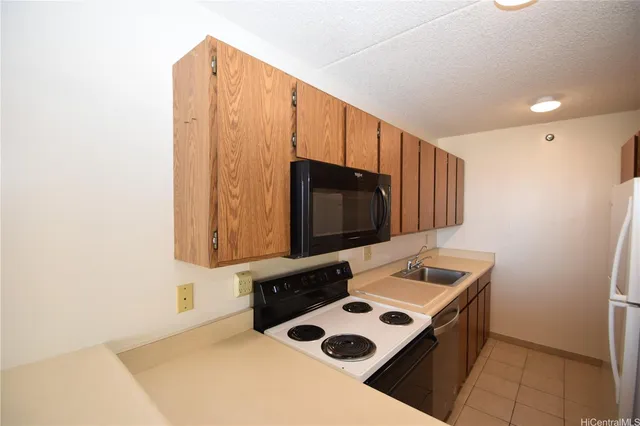 a kitchen with a sink a microwave and cabinets