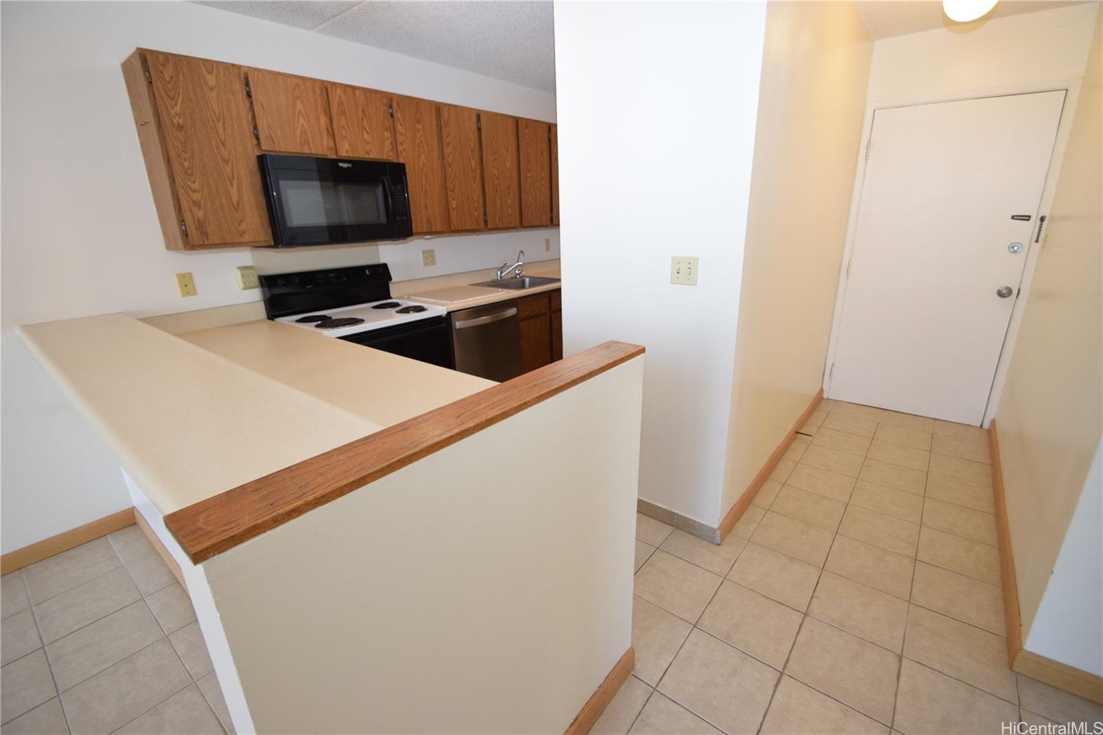 98-402 Koauka Loop, Unit 1916 Aiea, HI 96701 - Photo 8 of 24 a kitchen with a stove and a microwave