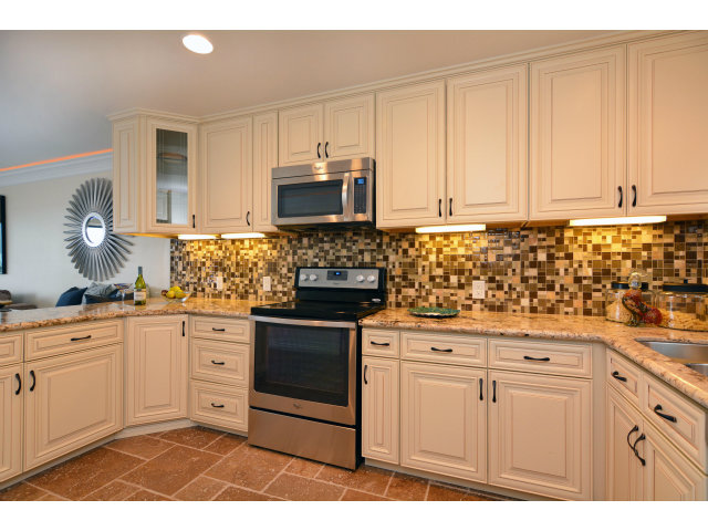 220 Beach Drive Aptos, CA 95003 - Photo 11 of 24 a kitchen with granite countertop white cabinets and stainless steel appliances