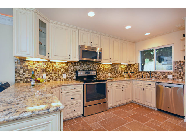 220 Beach Drive Aptos, CA 95003 - Photo 12 of 24 a kitchen with granite countertop white cabinets and stainless steel appliances