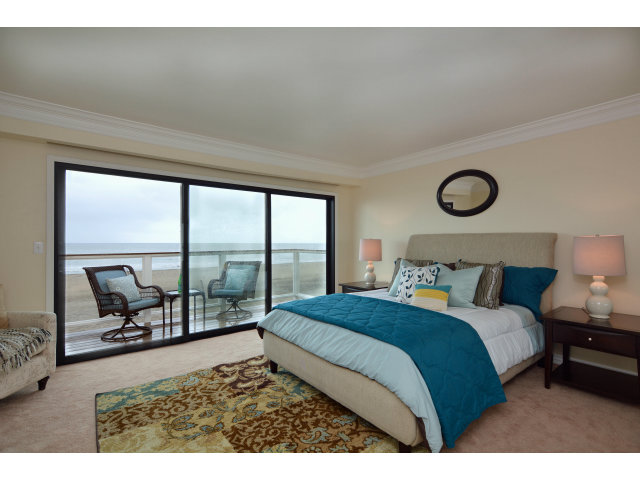 220 Beach Drive Aptos, CA 95003 - Photo 14 of 24 a bedroom with a large bed and a balcony view