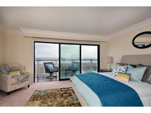 220 Beach Drive Aptos, CA 95003 - Photo 15 of 24 a bedroom with a bed and a large window