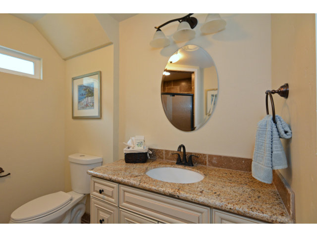 220 Beach Drive Aptos, CA 95003 - Photo 20 of 24 a bathroom with a granite countertop sink a toilet and a mirror