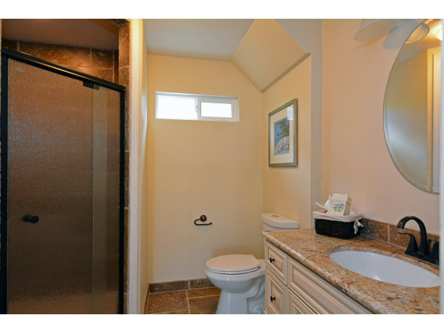 220 Beach Drive Aptos, CA 95003 - Photo 21 of 24 a bathroom with a granite countertop sink toilet and shower