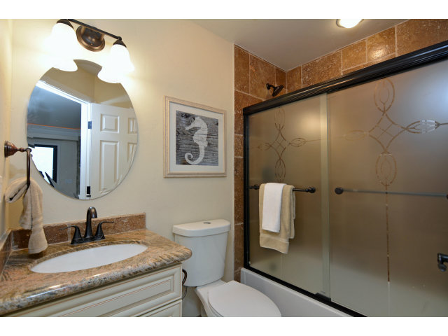 220 Beach Drive Aptos, CA 95003 - Photo 22 of 24 a bathroom with a granite countertop sink mirror vanity and toilet