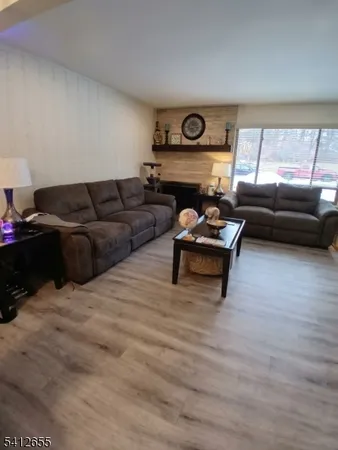 a table room with a table chairs a stove and a microwave