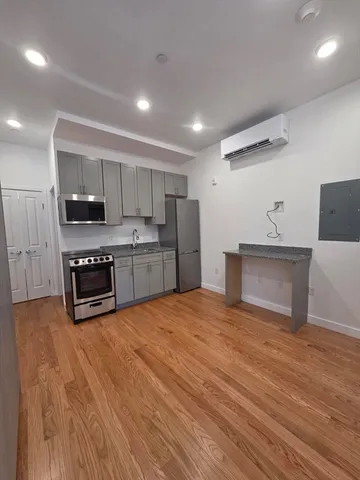 a kitchen with stainless steel appliances granite countertop a stove a sink and a refrigerator