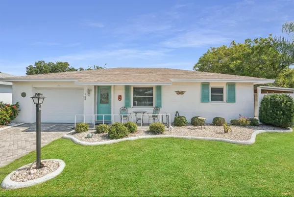 a backyard of a house with table and chairs