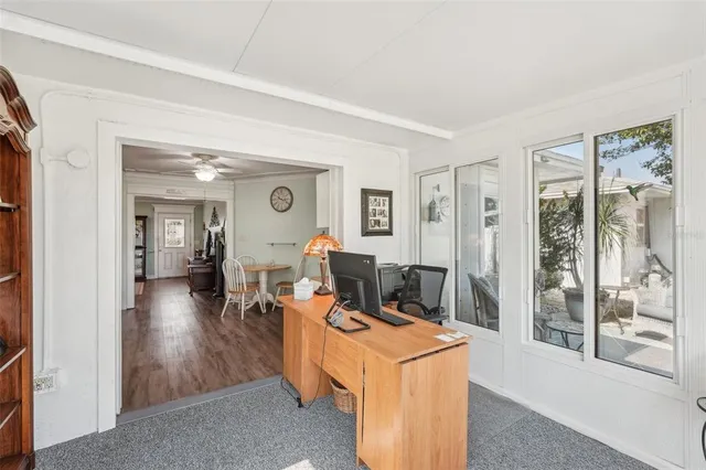 a living room with furniture a fireplace and a large window
