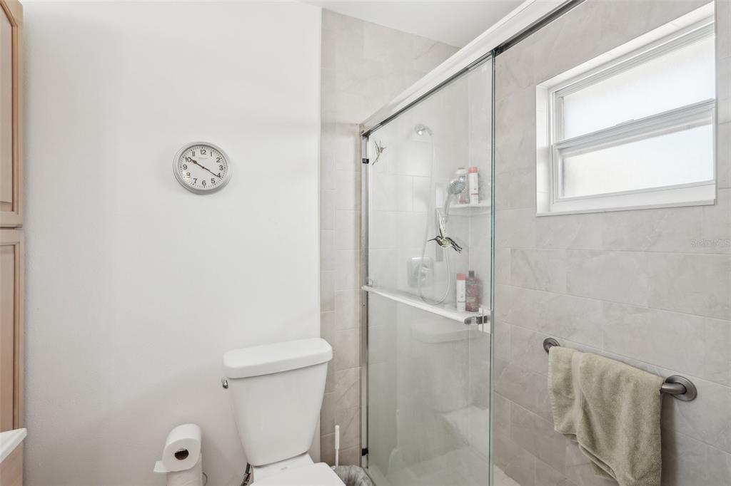 708 Rutgers Place Sun City Center, FL 33573 - Photo 18 of 27 a bathroom with a toilet and a shower