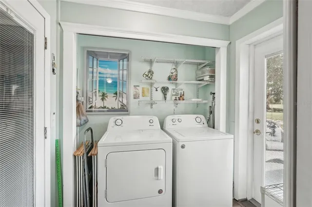 a utility room with dryer washer and other items
