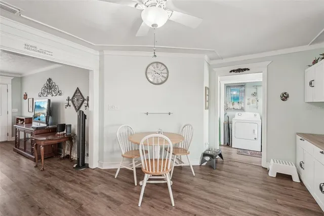 a kitchen with stainless steel appliances kitchen island granite countertop a refrigerator a stove top oven a sink and dishwasher with wooden floor