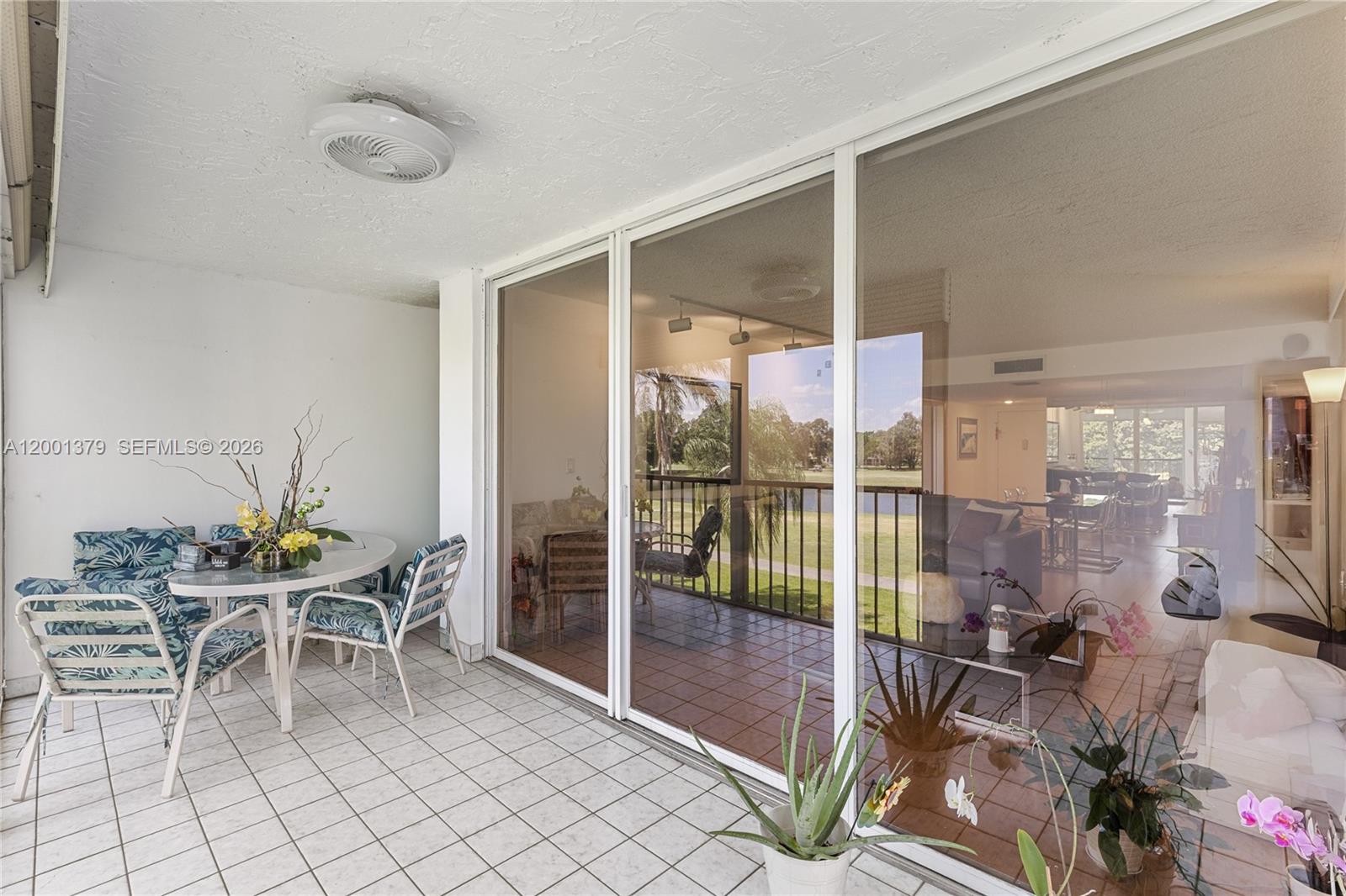 16251 Golf Club Road, Unit 311 Weston, FL 33326 - Photo 30 of 38 a dining room with furniture and floor to ceiling window