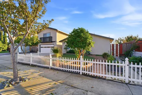 a front view of a house with wooden fence