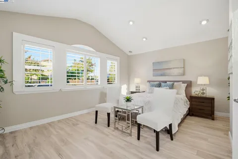 a bed room with a bed and a chair