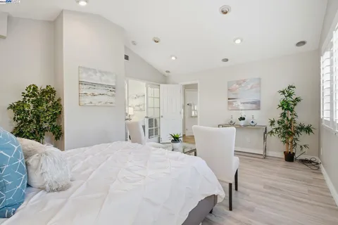 a bedroom with a bed and a potted plant