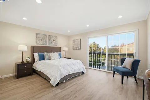 a bedroom with a bed and a large window