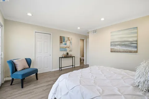 a bedroom with a bed and a chair