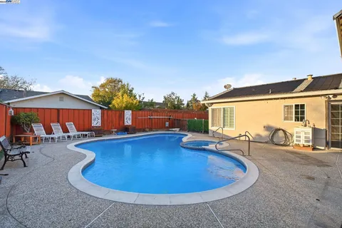 swimming pool view with a seating space