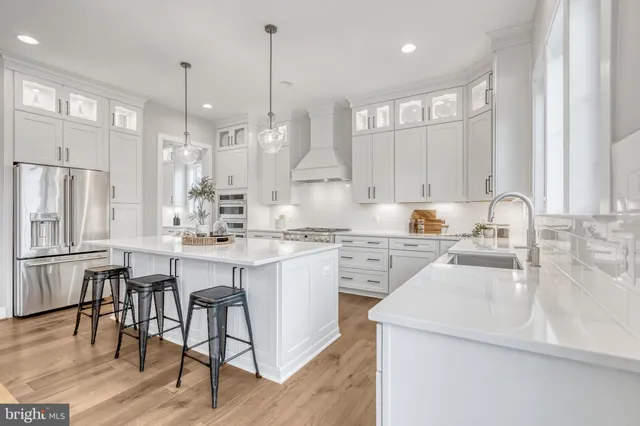 a living room with furniture a fireplace and a floor to ceiling window