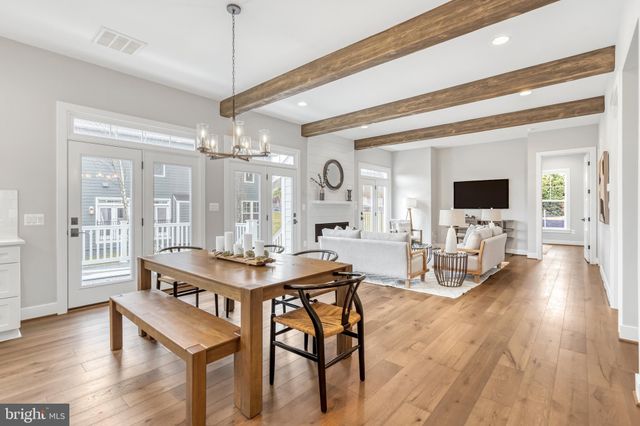 a living room with furniture fireplace and a large window