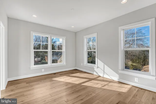 a spacious bathroom with a bathtub shower sink mirror and toilet