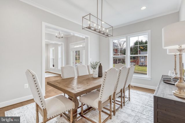 a kitchen with stainless steel appliances kitchen island a chandelier and refrigerator