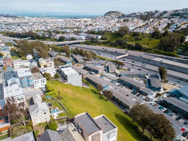 an aerial view of residential houses with outdoor space