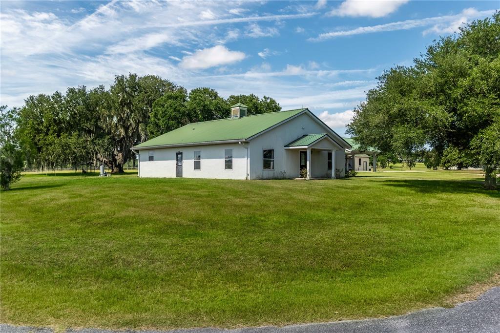 12520 Northwest 160th Street Reddick, FL 32686 - Photo 50 of 71 a yellow house with garden in front of it