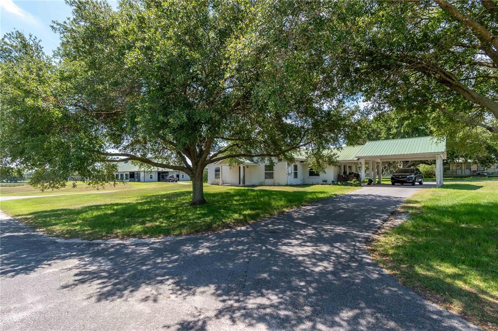 12520 Northwest 160th Street Reddick, FL 32686 - Photo 63 of 71 a view of a house with garden and trees
