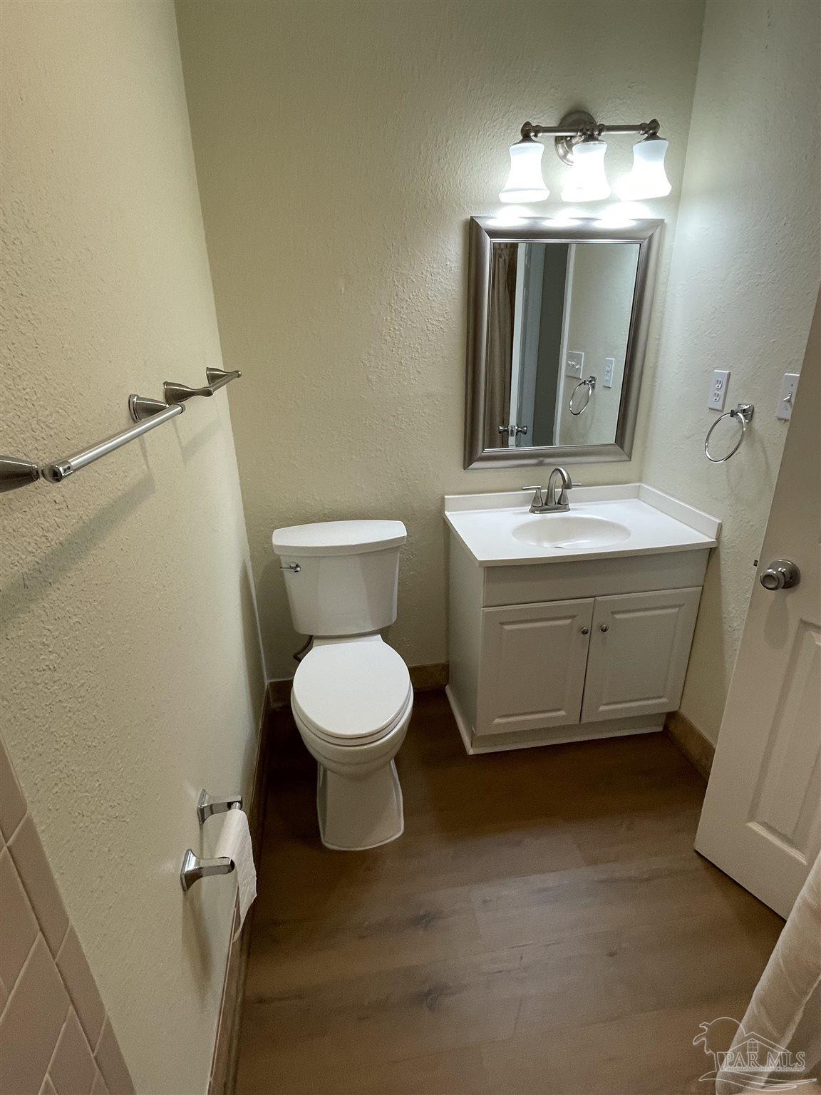 4140 April Road Pensacola, FL 32504 - Photo 7 of 12 a bathroom with a toilet sink and mirror