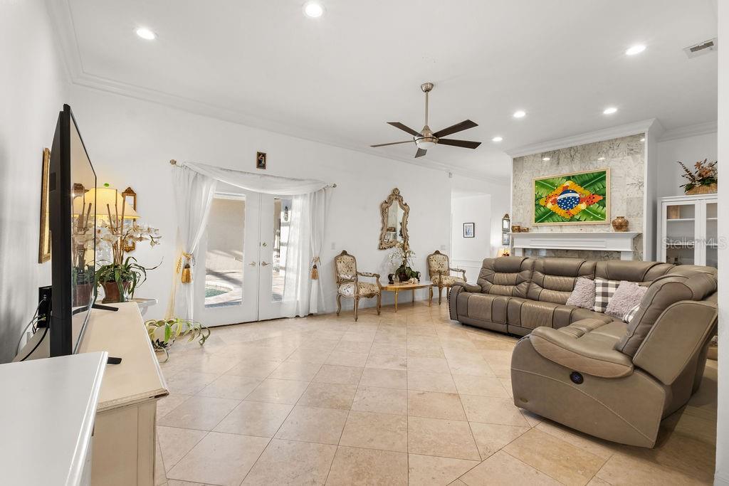 2958 Marquesas Court Windermere, FL 34786 - Photo 15 of 32 a living room with furniture a chandelier and a flat screen tv