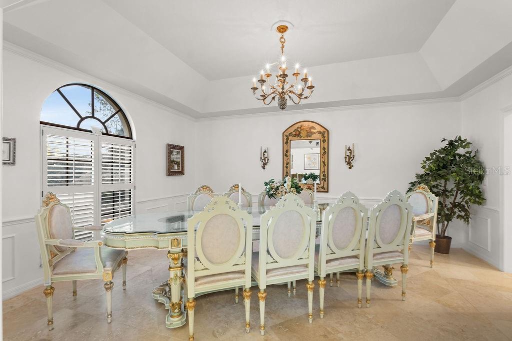 2958 Marquesas Court Windermere, FL 34786 - Photo 17 of 32 a view of a dining room with furniture a chandelier and wooden floor