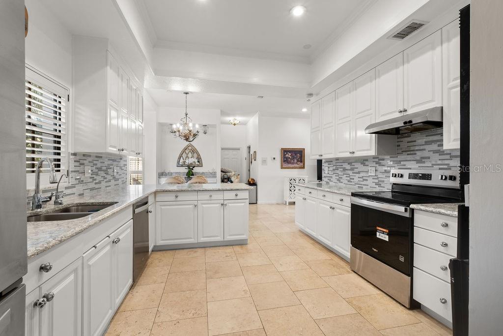 2958 Marquesas Court Windermere, FL 34786 - Photo 19 of 32 a large white kitchen with a stove a sink dishwasher and a refrigerator