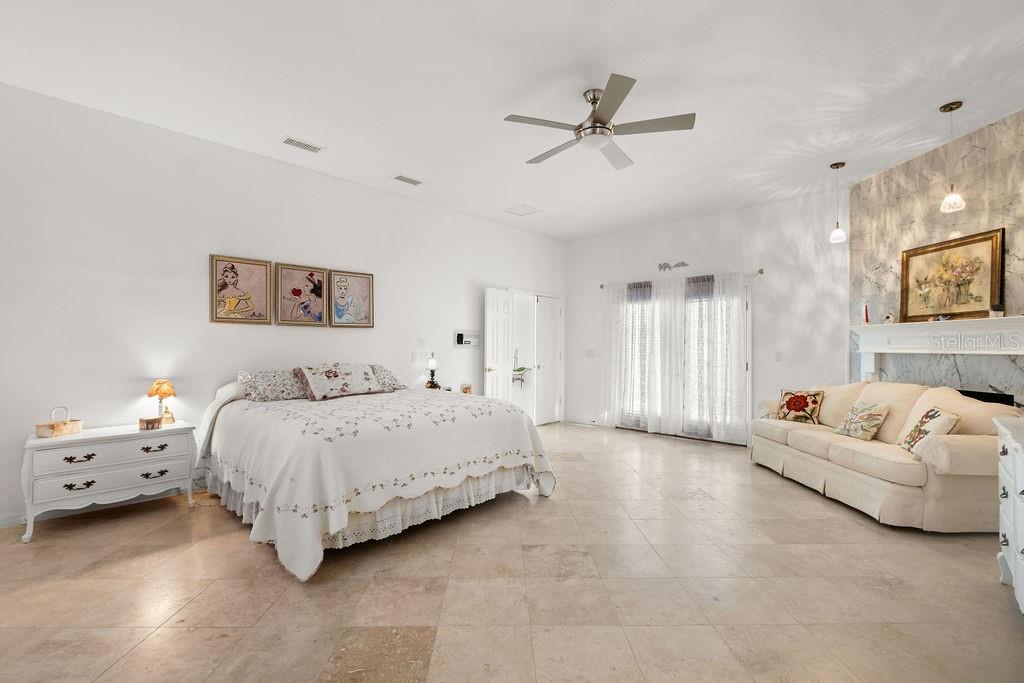 2958 Marquesas Court Windermere, FL 34786 - Photo 22 of 32 a spacious bedroom with a bed and a couch