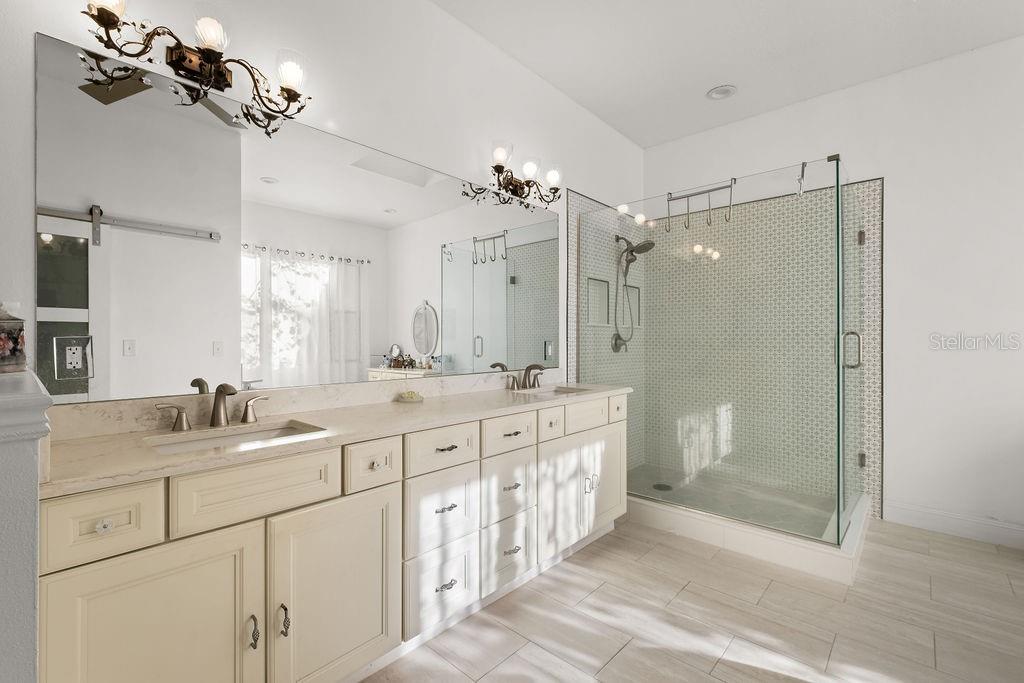 2958 Marquesas Court Windermere, FL 34786 - Photo 26 of 32 a bathroom with a double vanity sink mirror double and shower