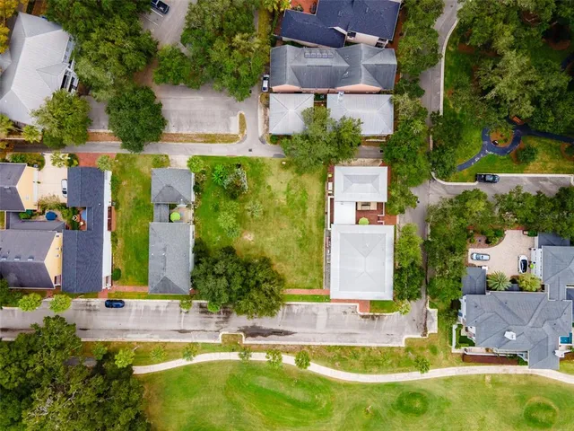 an aerial view of residential houses with outdoor space and swimming pool
