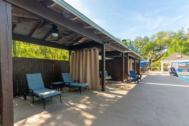 a view of a patio with table and chairs and potted plants