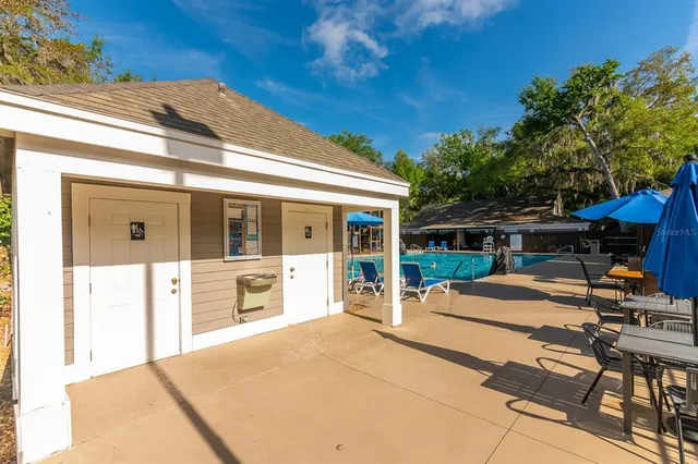a view of a house with backyard porch and sitting area