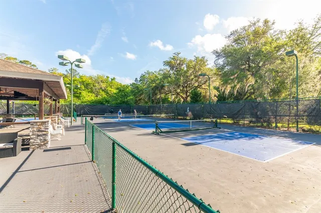 a view of a swimming pool with a patio and a yard